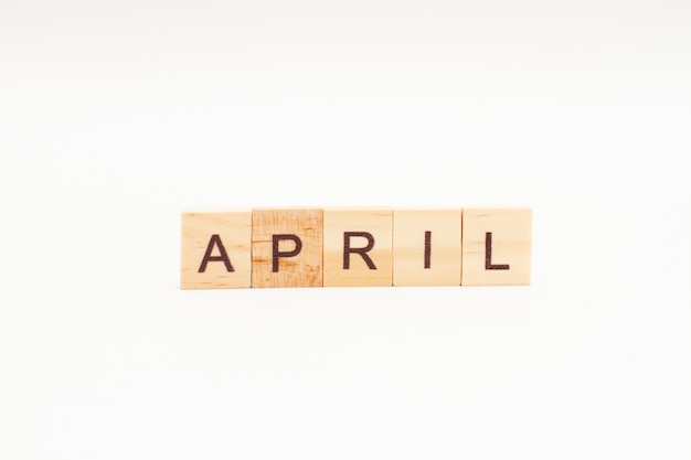 Word APRIL made of wooden blocks isolated