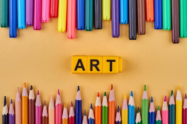 Word art on plastic blocks in frame from multicolored markers and pencils