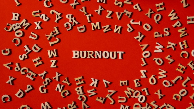 Word burnout made out of wooden letters on bright red background motivational words quotes concept