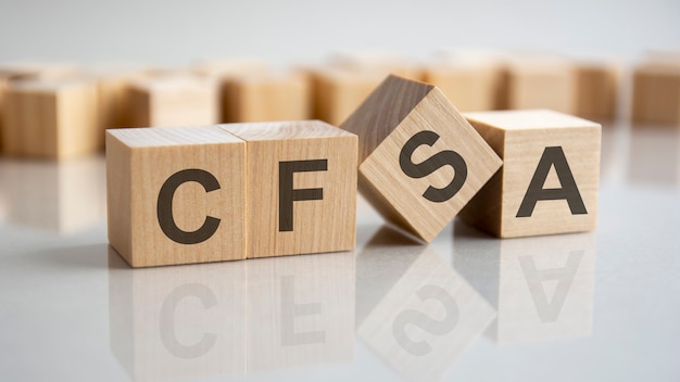 Word CFSA on wooden cubes, gray background