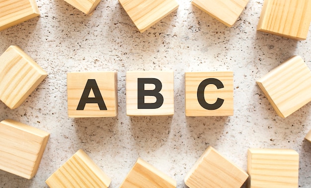 The word consists of wooden cubes with letters, top view on a light background. Work space.