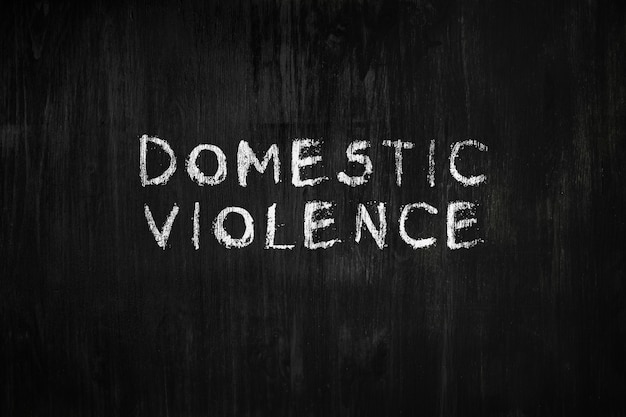 the word domestic violence on a blackboard