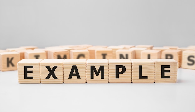 Word EXAMPLE made with wood building blocks