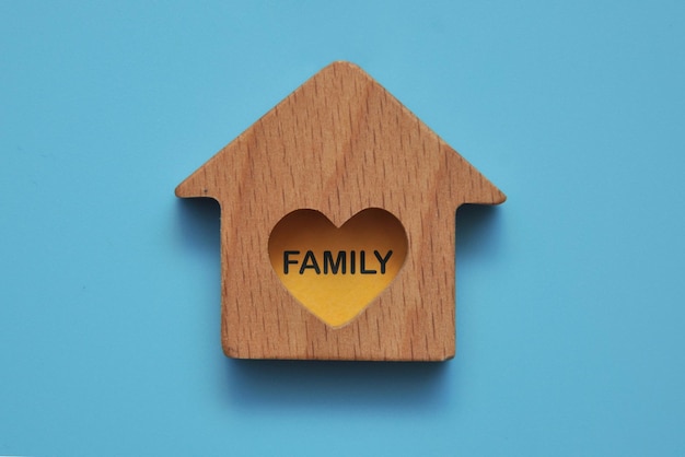 The word "Family" on a wooden house. A symbol of love for the family