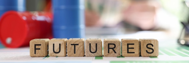 Word futures collected from wooden cubes with oil barrels on office table and blurred business