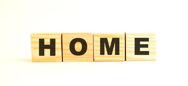 The word HOME. Wooden cubes with letters isolated on white background.