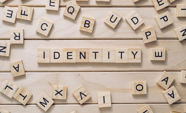 Word Identity made with letter blocks on wooden background