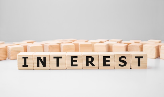 Word INTEREST made with wood building blocks