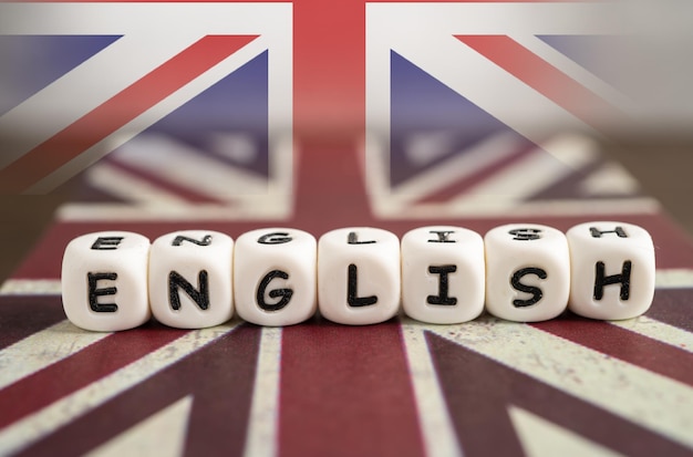 Word Learn English on book with United Kingdom flag learning English language courses concept