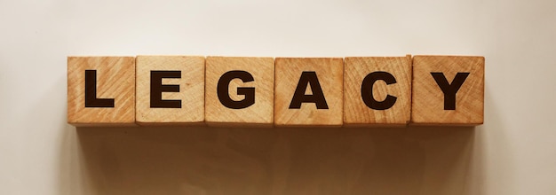 Word LEGACY on Wooden cubes on light background with shadow Last will Concept