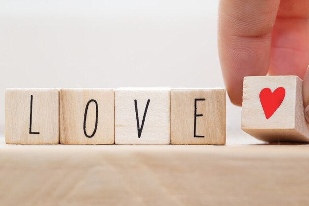 Word Love on wooden cubes with red heart