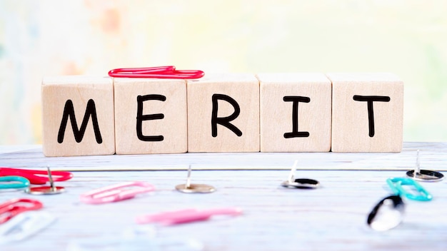 Word merit The word Merit written on wood cube Business concept