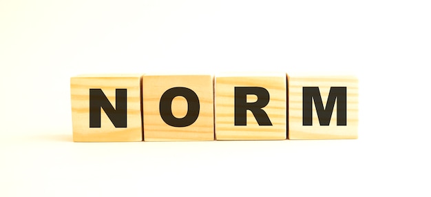 The word NORM. Wooden cubes with letters isolated on white background.