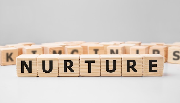 Word NURTURE made with wood building blocks