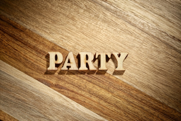 Word party made with wooden letters on the wood board