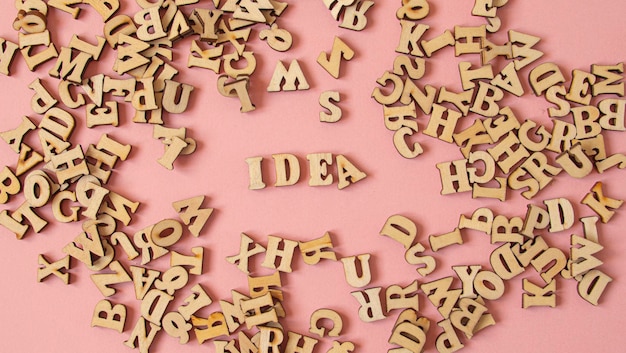 Word quotIdeaquot written with wooden letters on a pink background