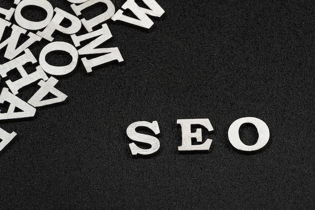 Word SEO is composed of white letters on black background Website optimization concept