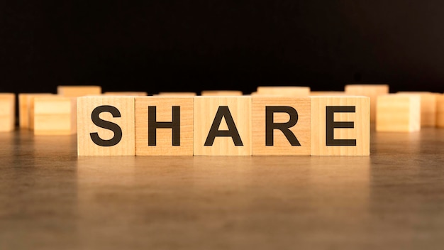 Word SHARE written on wooden cube block stack on black background business concept