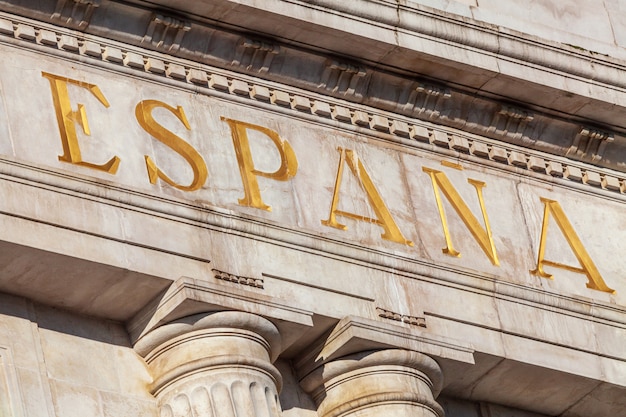 Word Spain in Spanish sculpted in stone and golden color