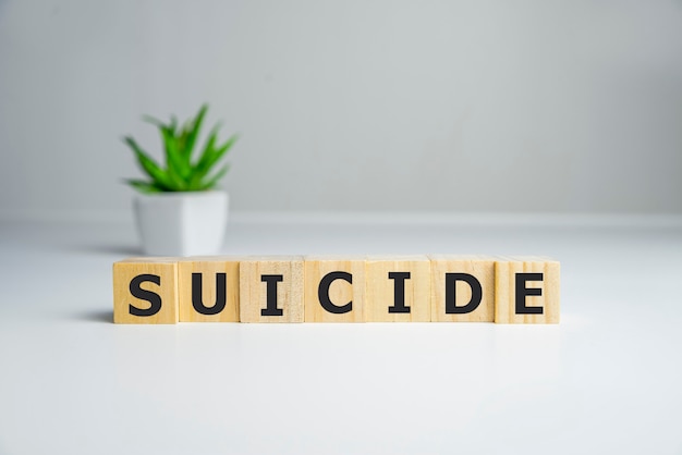 Word suicide text spelled on wooden cubes