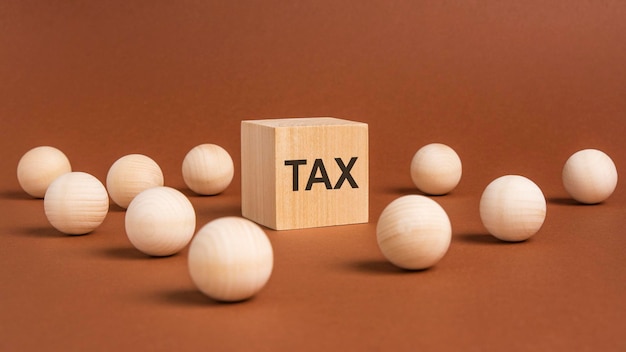 Word tax on wooden block wooden balls around concept