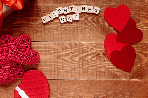 The word Valentine's Day. Love on wooden blocks on natural background. Theme of love, heart and gift.