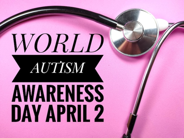 Word WORLD AUTISM AWARENESS DAY APRIL 2 on pink background with stethoscope