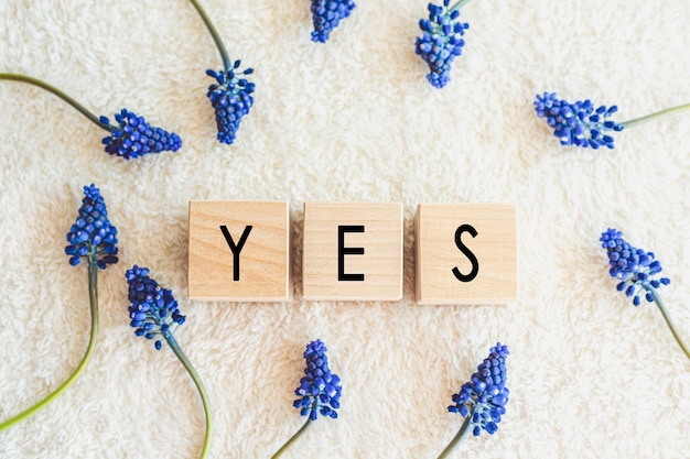 The word yes written in black letters on wood blocks