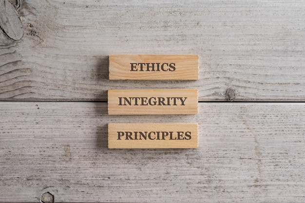 Words Ethics Integrity and Principles written on three stacked wooden blocks