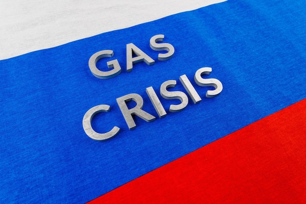 The words gas crisis laid with silver letters over flat russian flag surface