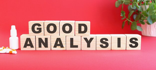 The words GOOD ANALYSIS is made of wooden cubes