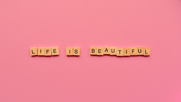 Words "Life is beautiful" on a pink paper