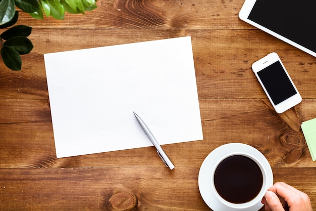 Work desk with open blank notebook for notes on brown wooden table