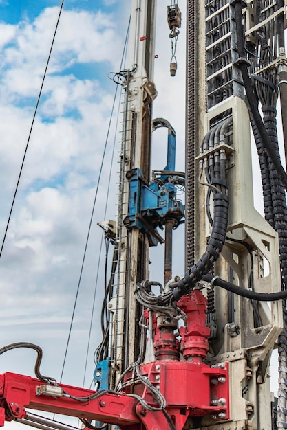 Work of a drilling rig at a construction site against a background of blue sky Exploration of useful minerals Industry and construction