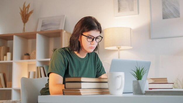 Work fatigue exhausted student job burnout tired overworked woman typing laptop sitting desk