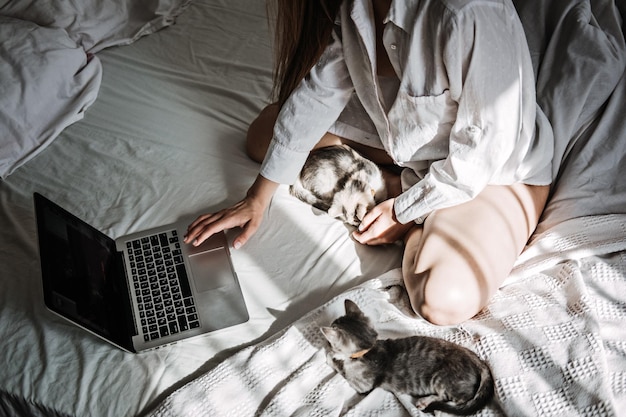 Work from home jobs remote online work home office woman working on laptop in bed