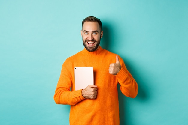 Work from home, technology concept.  man holding laptop, showing thumb up, approve and like