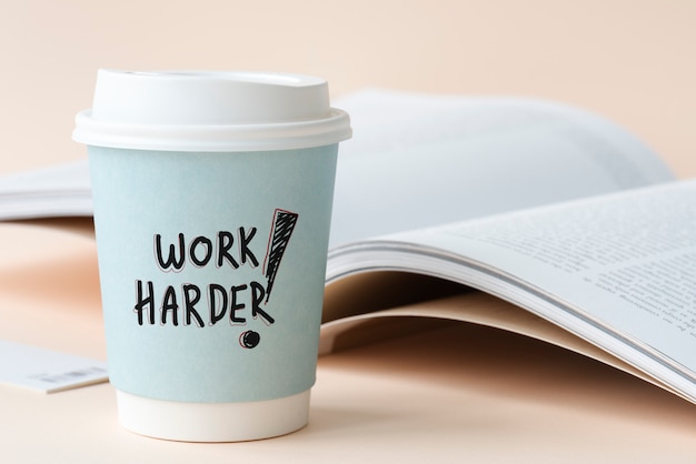 Photo work harder written on a paper cup