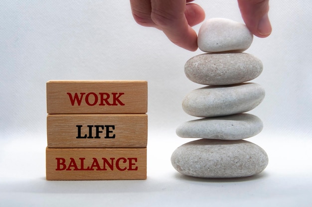 Work life balance text on wooden blocks with balanced white stones background New ways of working concept