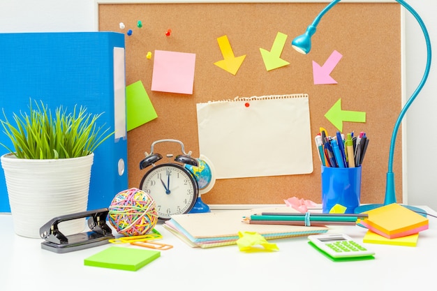 Work place of a creative person with a variety of colorful stationery objects