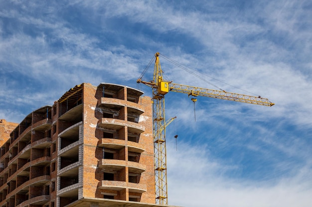 Work in progress on a new apartment block Tall building under construction with cranes Construction Site of New Building