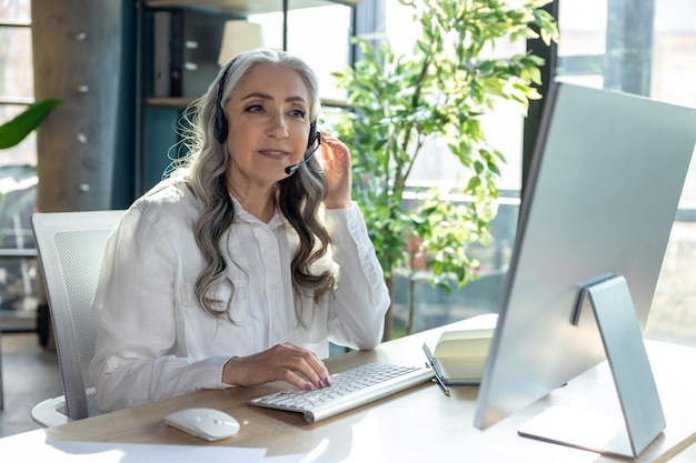 Work on project Goodlooking mature business woman at the computrer looking busy