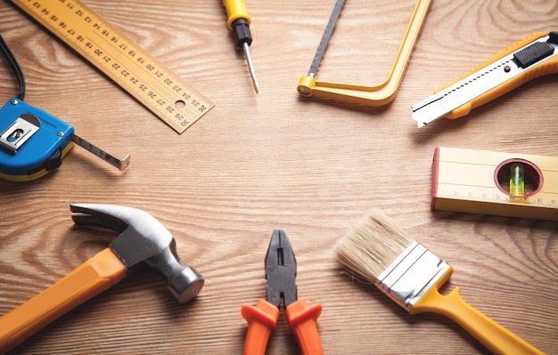 Work tools on wooden background.