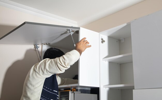 Worker assembling of new kitchen furniture