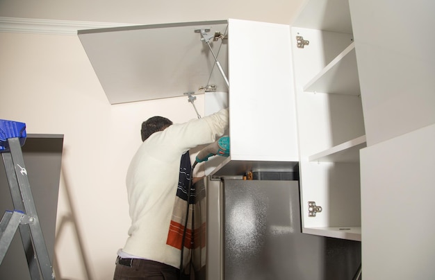 Worker assembling of new kitchen furniture