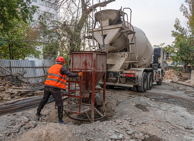 Worker on a construction site building infrastructure with machinery and tools Pouring concrete