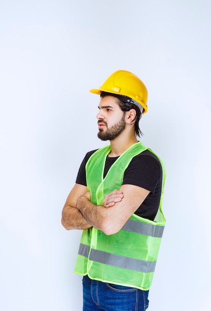 Worker crossing his arms and looks dissatisfied.