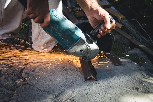 Worker cutting metal with grinder