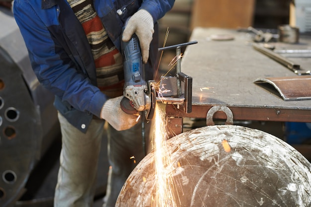 Worker Cutting Metal