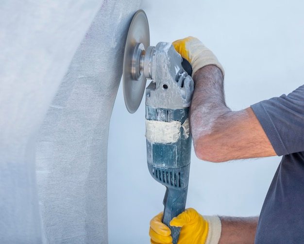 Worker cutting stone with grinder